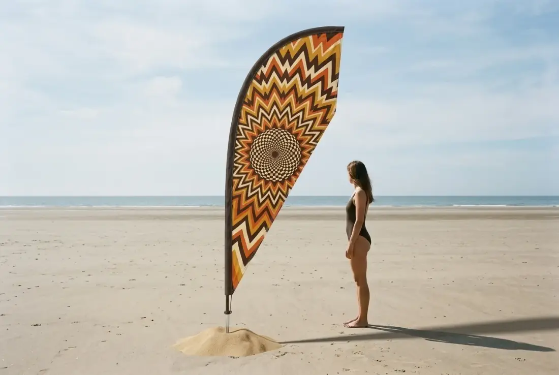 Helios Teardrop Flag next to an adult for size