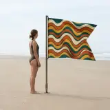 Swell Swallowtail Flag next to an adult for size