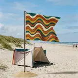 Swell Swallowtail Flag set up on the beach